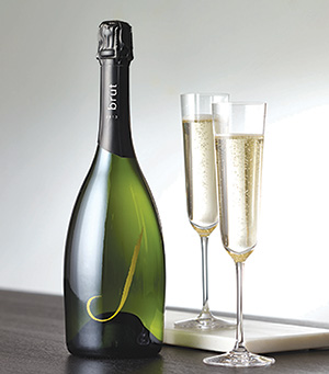Bottle of J wine sparkling wine with two flutes