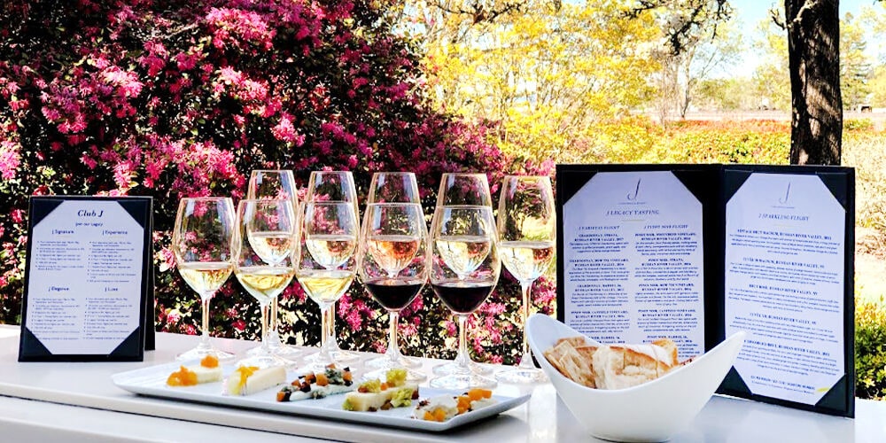 Tasting menu laid out on table with wine glasses